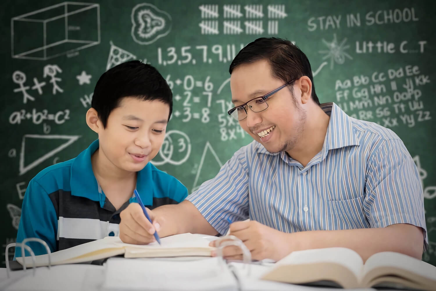 teacher teaching a boy at a math tuition centre in Hougang Singapore
