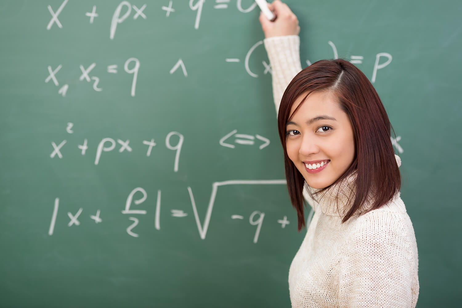 singaporean female student doing math on a blackboard
